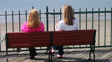 women sitting on bench